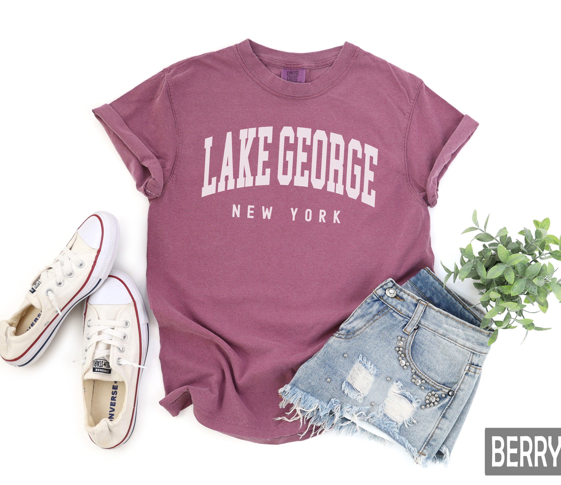 a t - shirt that says lake george, new york next to a pair of