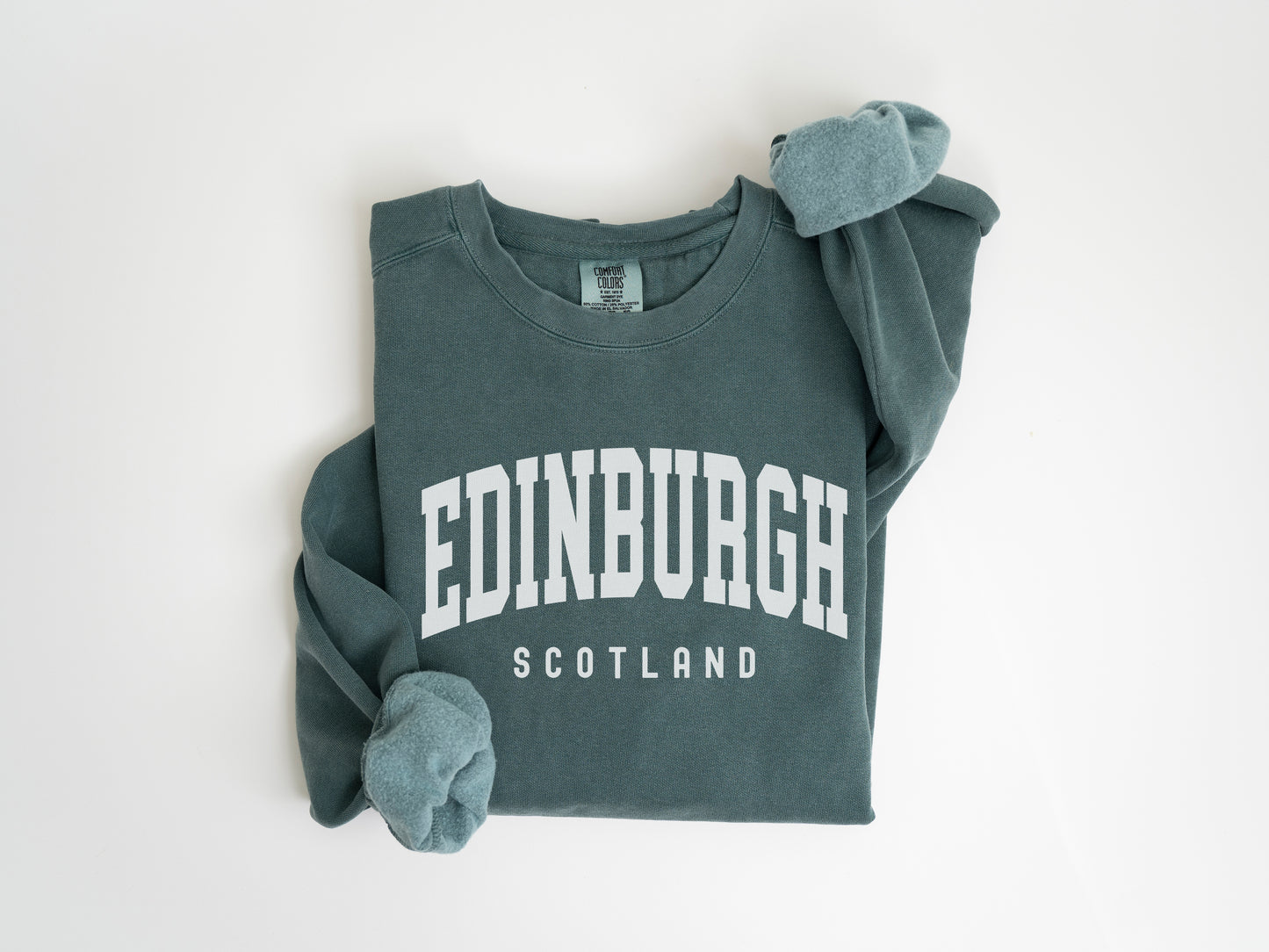 a green shirt with a white edinburgh on it