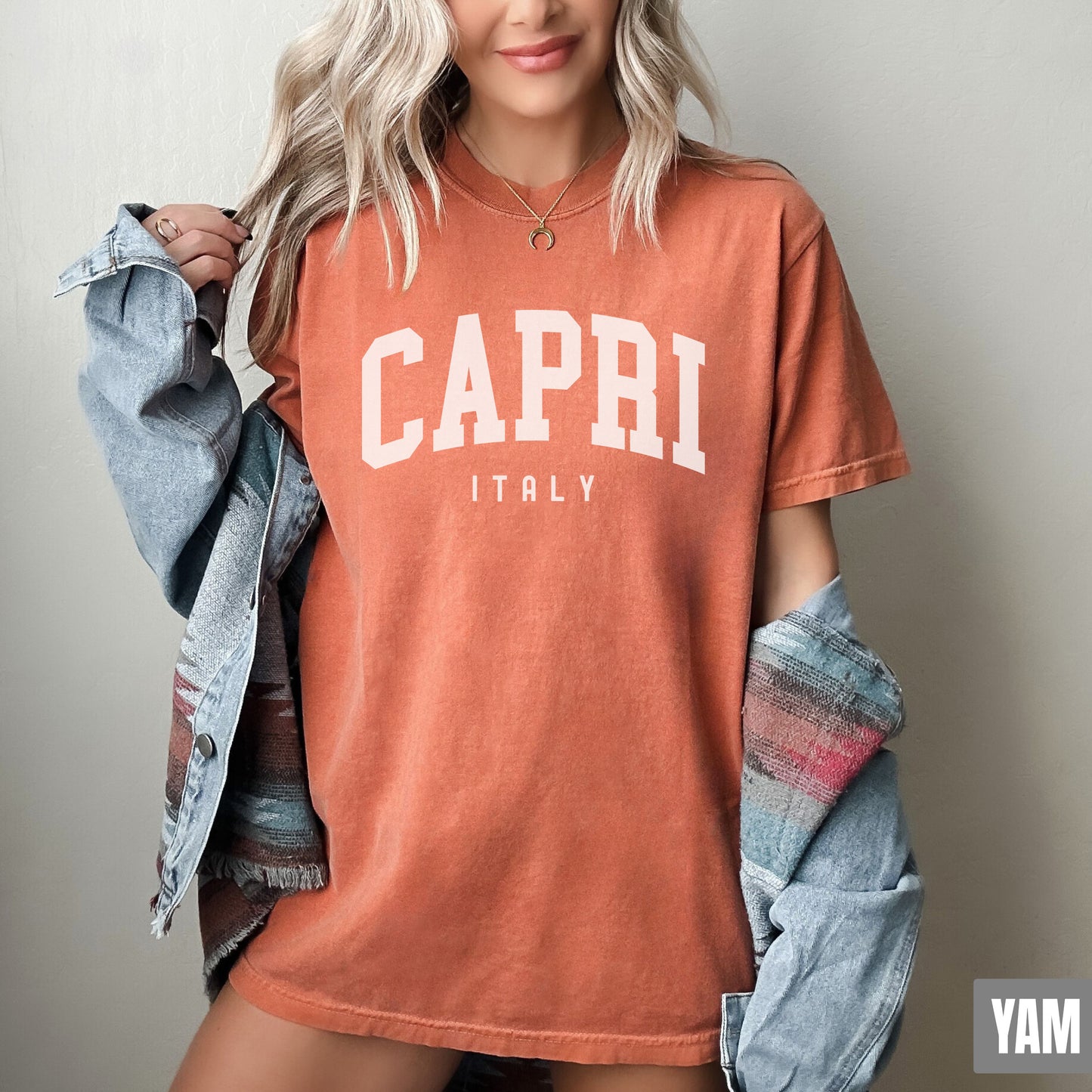 a woman with blonde hair wearing a capri t - shirt