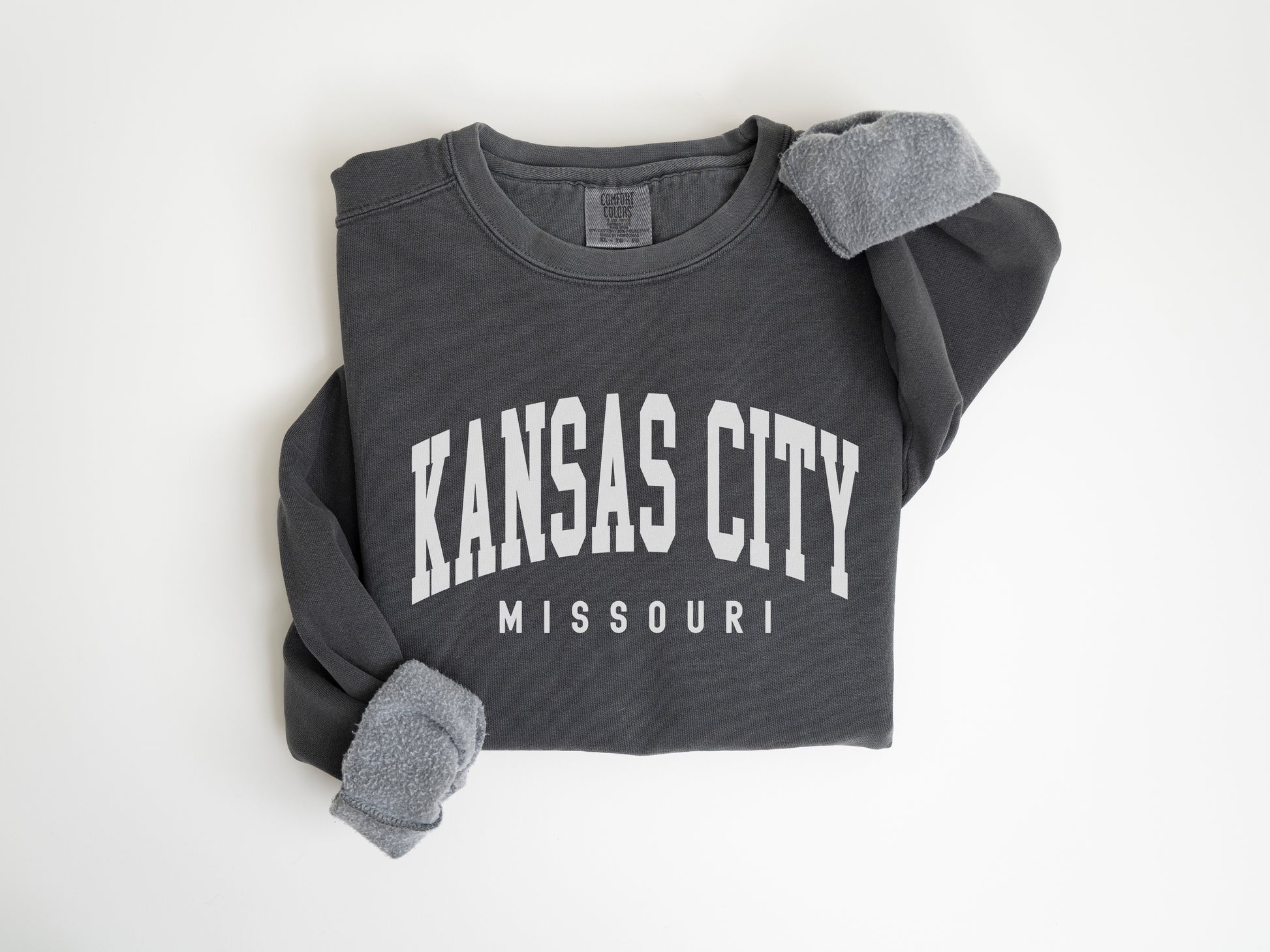 a black kansas city sweatshirt with a pair of mittens on it