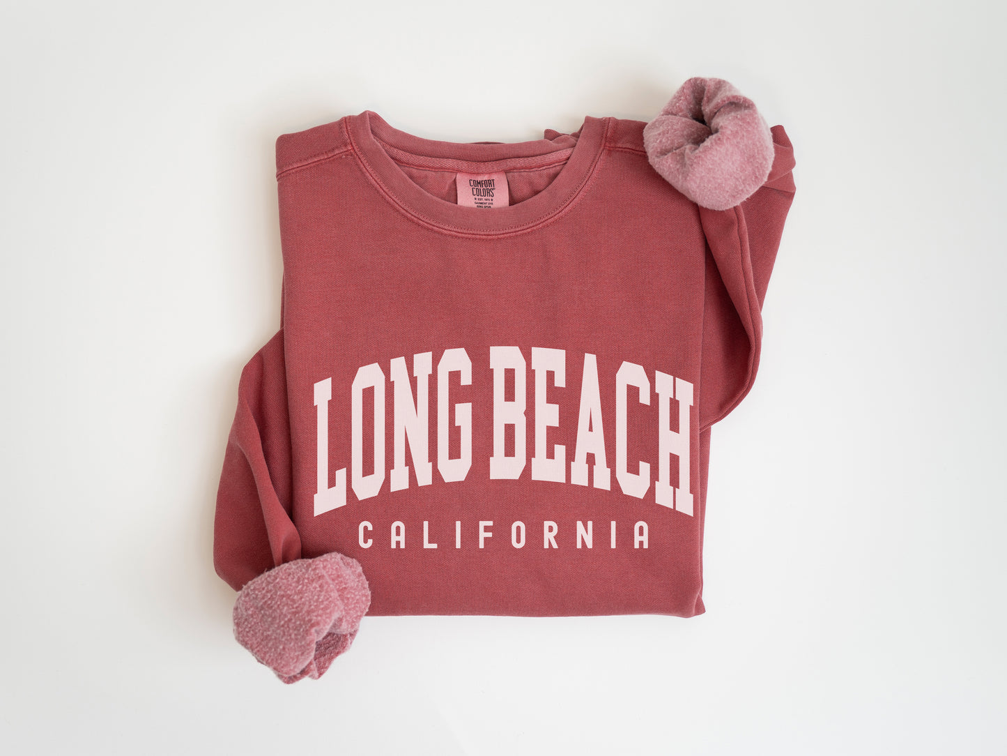 a red long beach shirt with a pair of slippers on it