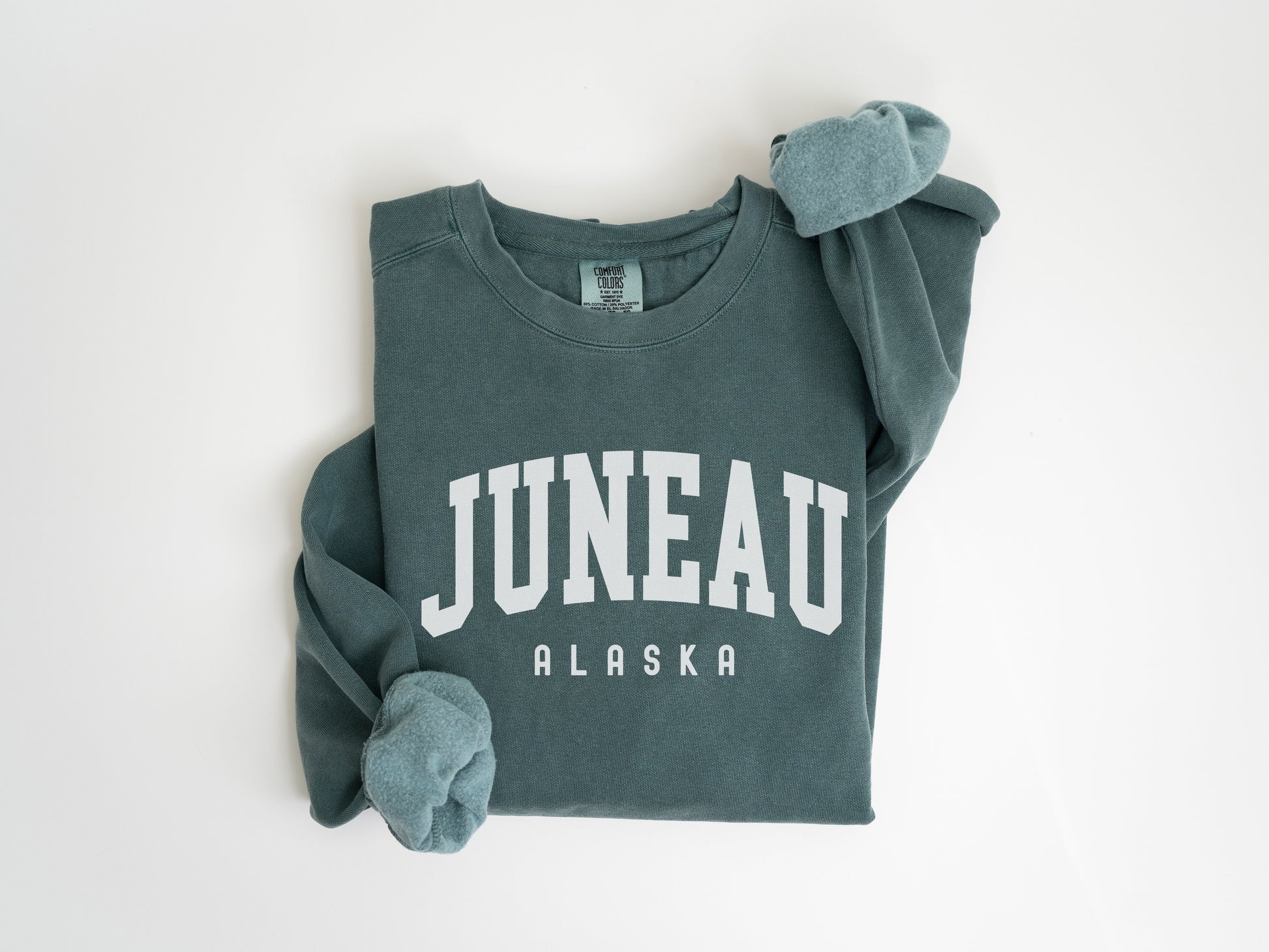 a green sweatshirt with the word juneau on it