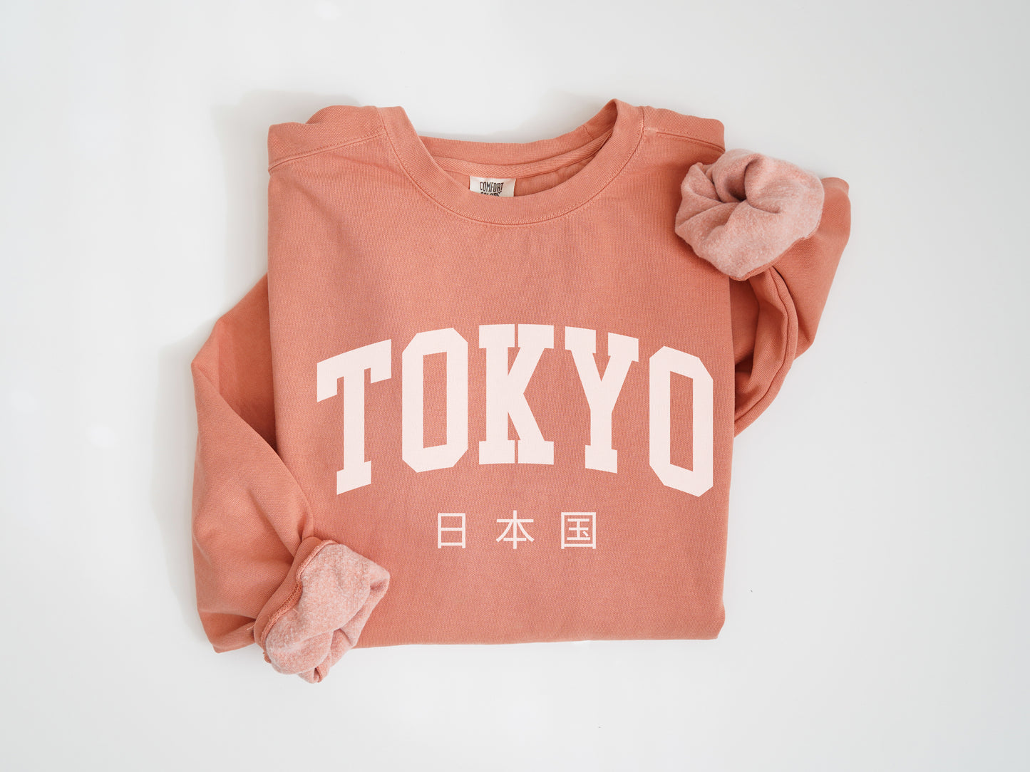 a pink sweatshirt with the word tokyo on it