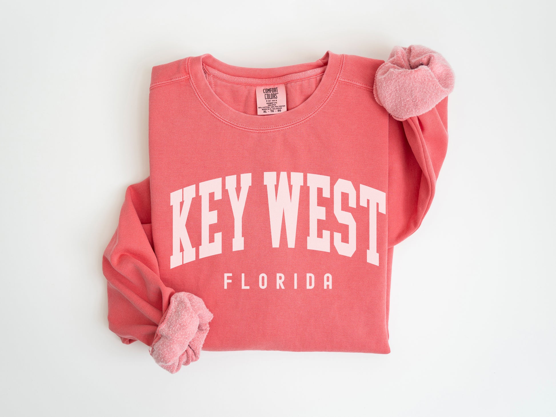 a red shirt with a white key west on it