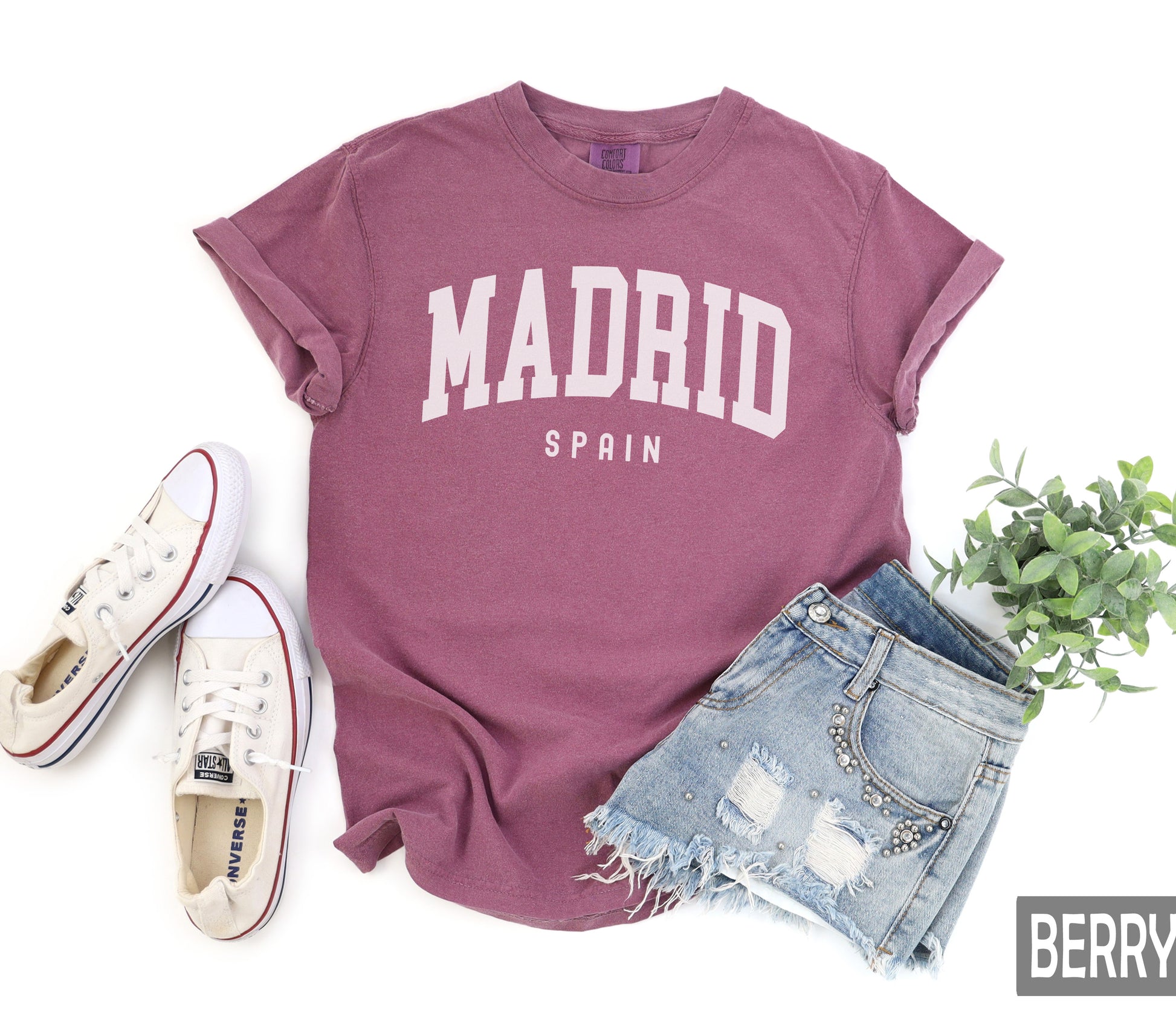 a t - shirt with the word madrid on it next to a pair of shorts