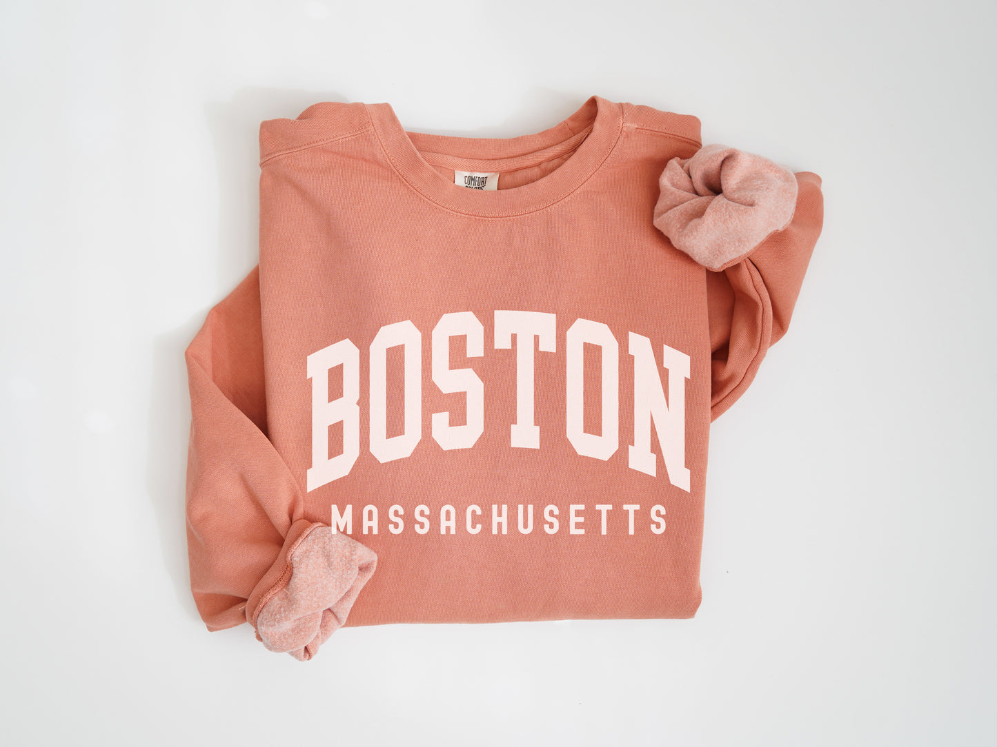 a red boston sweatshirt with a pink bow on it