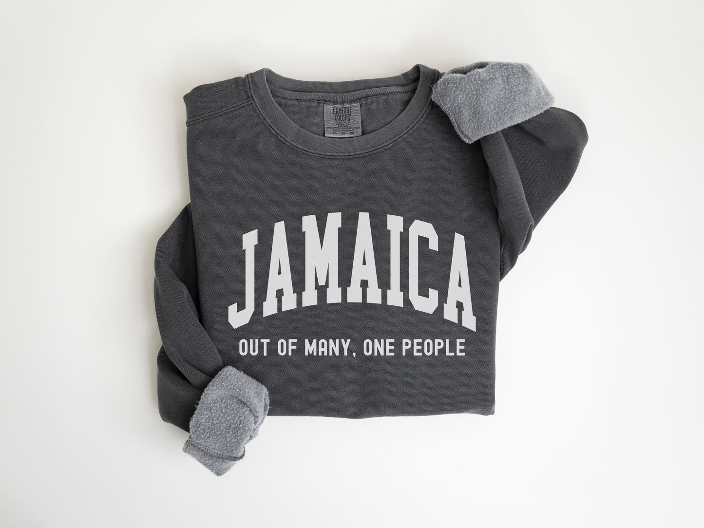 a black sweatshirt with the words jamaica out of many one people on it