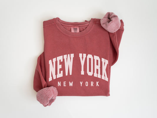 a red new york sweatshirt with a pair of mittens on it