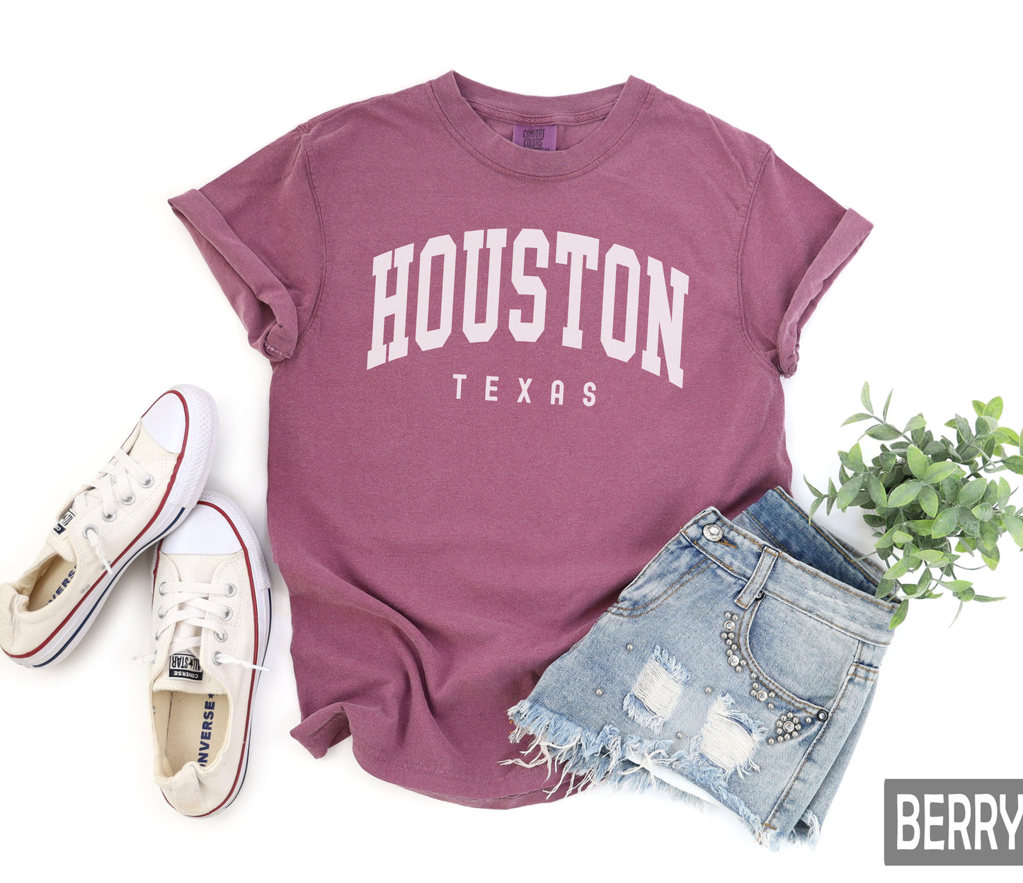 a t - shirt that says houston texas next to a pair of shorts