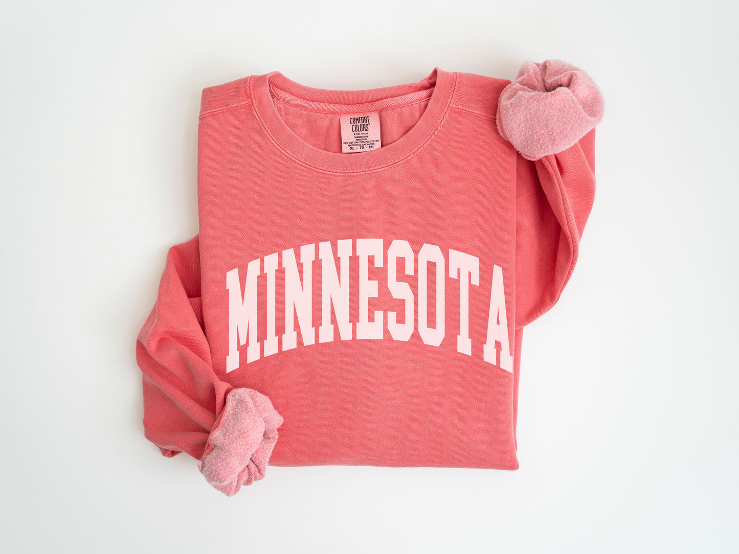 a red shirt with a white minnesota on it