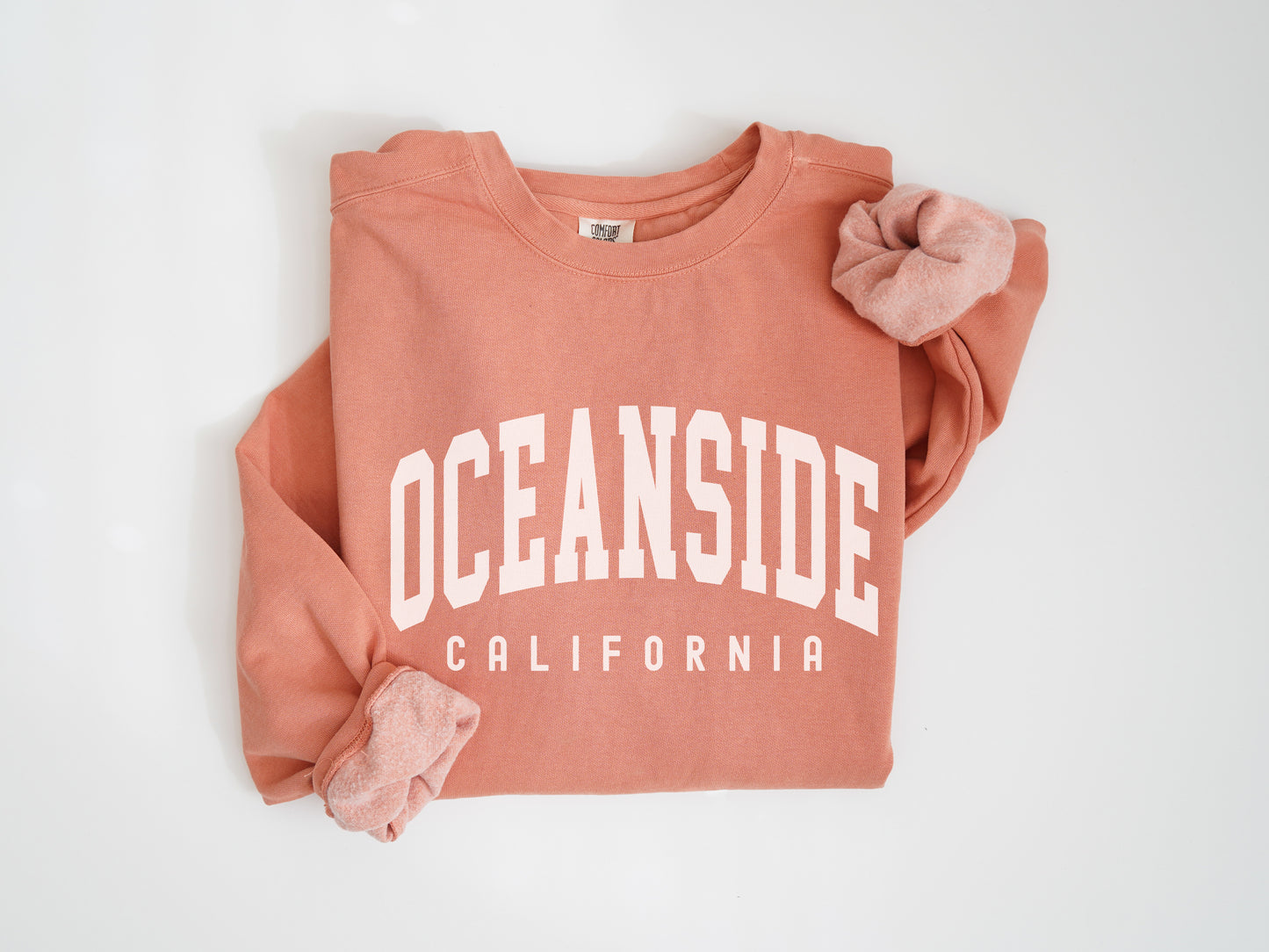 a pink sweatshirt with the words oceanside on it