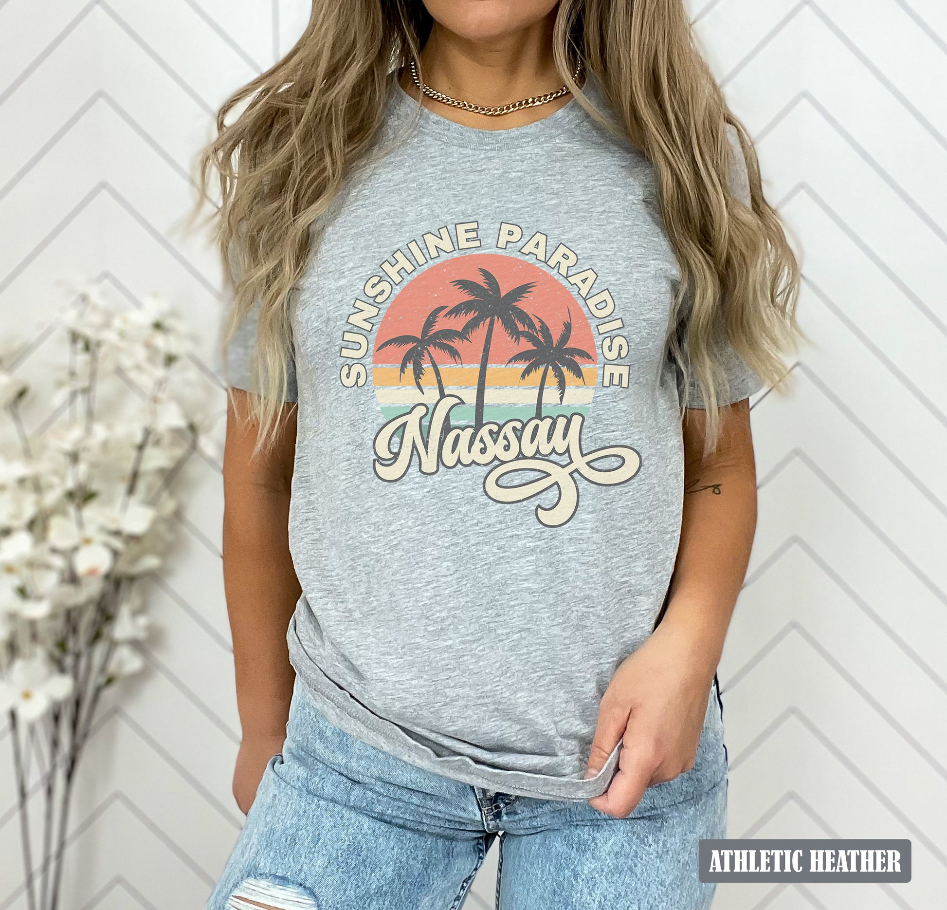 a woman wearing a grey shirt with a palm tree on it