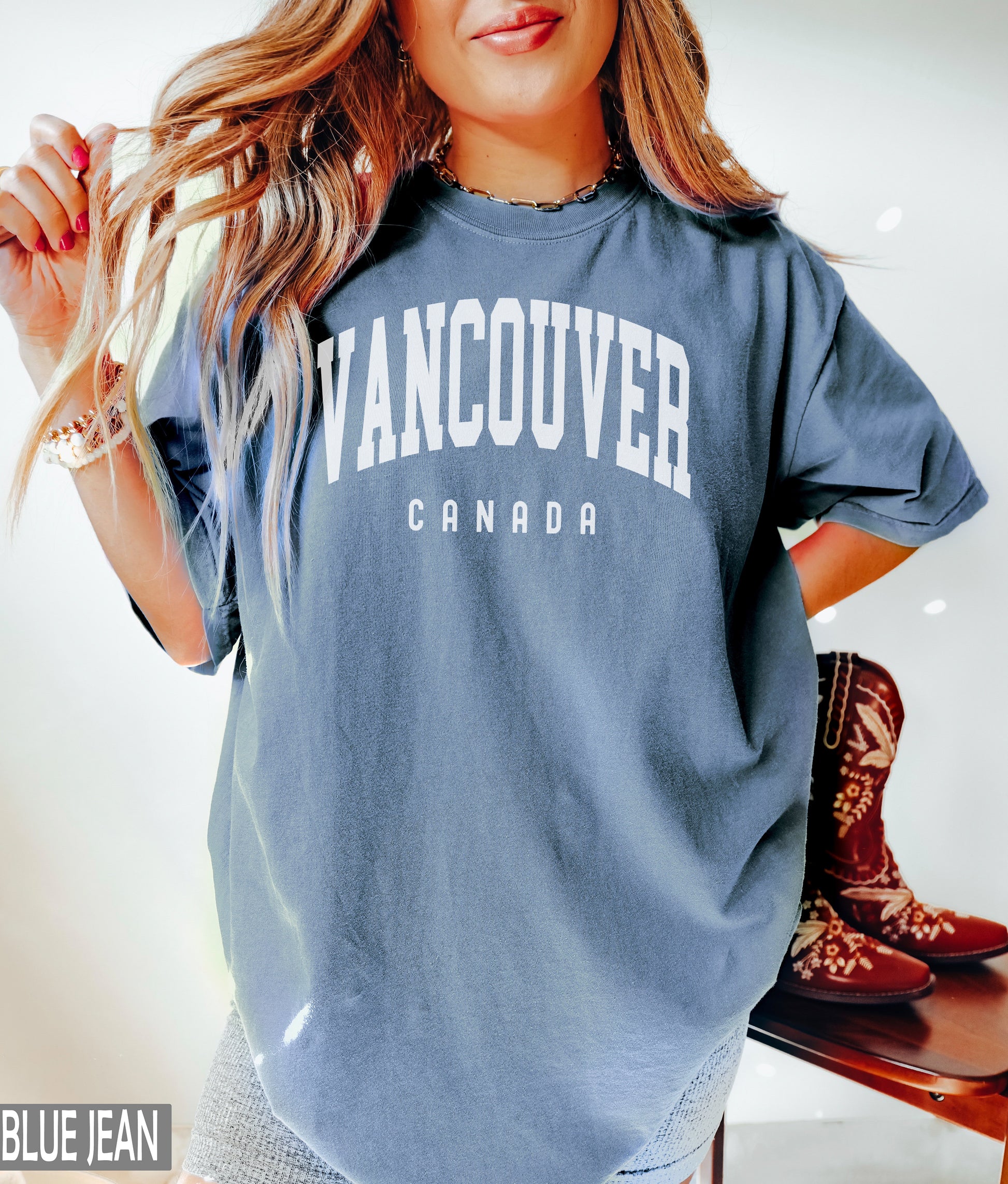 a woman posing for a picture wearing a vancouver t - shirt