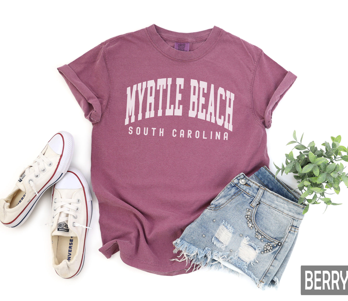 a t - shirt that says my little beach, south carolina next to a pair