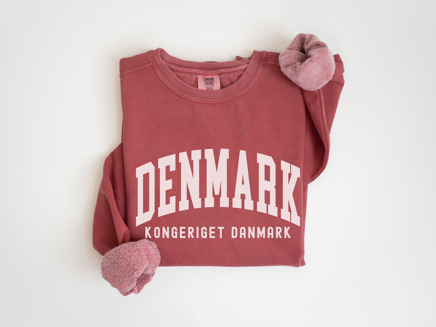 a red sweatshirt with the word denmark on it