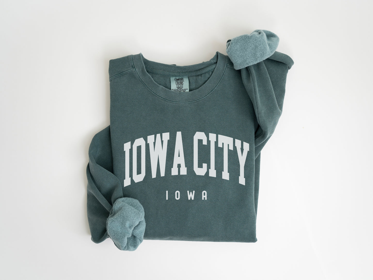 a green sweatshirt with the word iowa on it