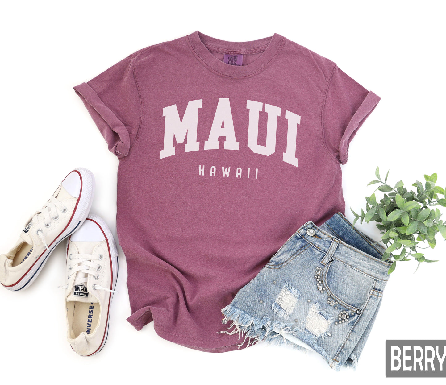 a shirt that says mauu hawaii next to a pair of shorts