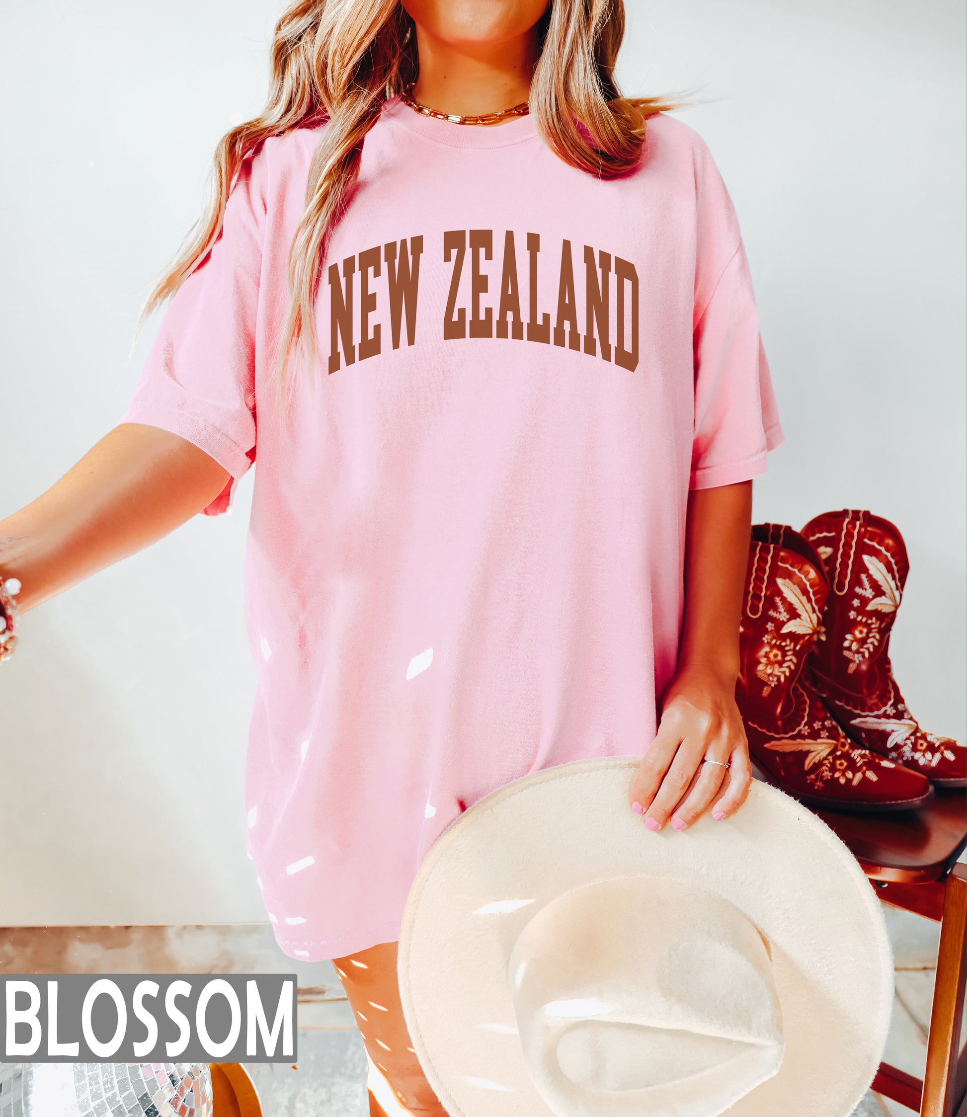 a woman in a pink shirt and cowboy boots