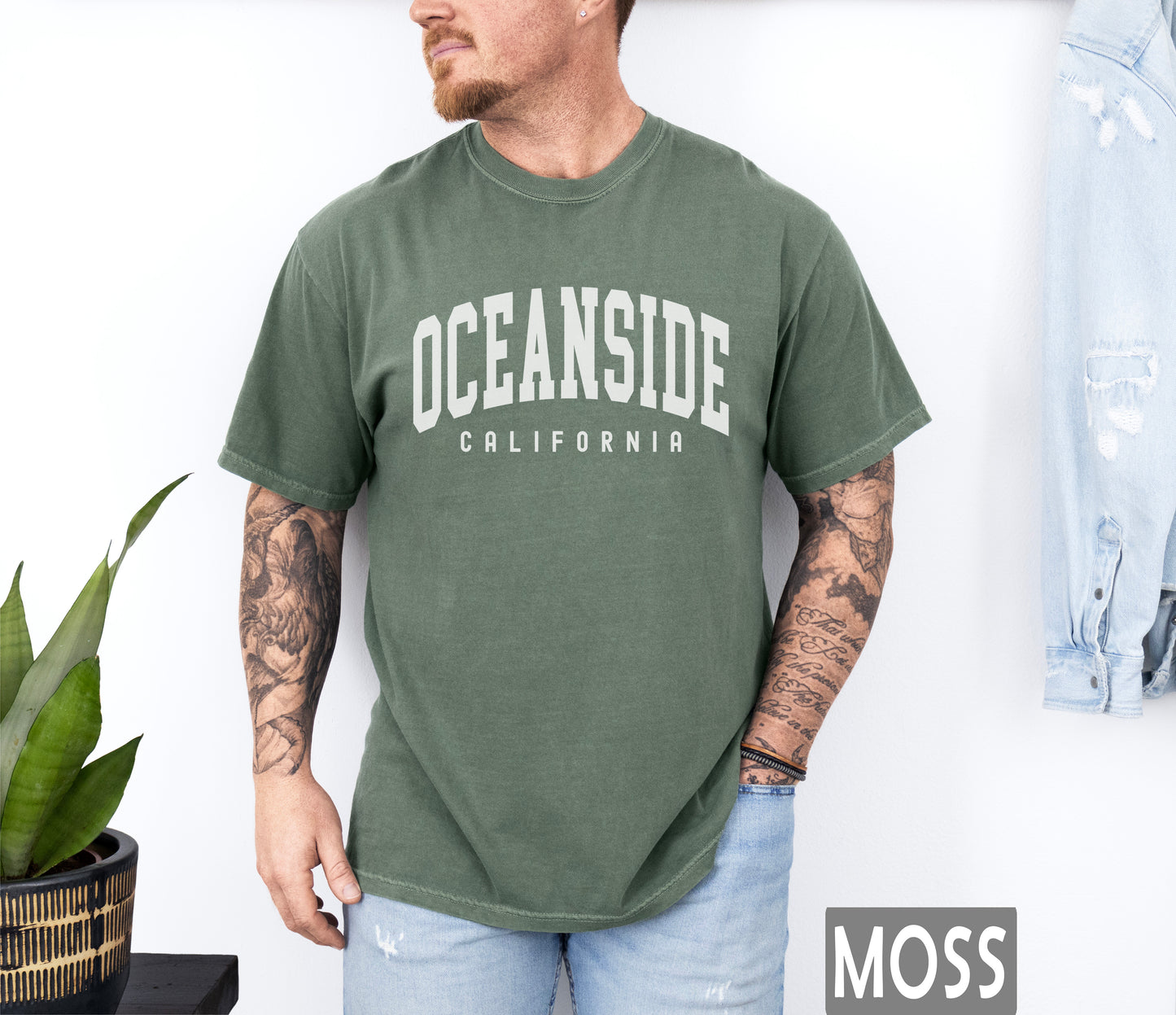 a man wearing a green oceanside california t - shirt