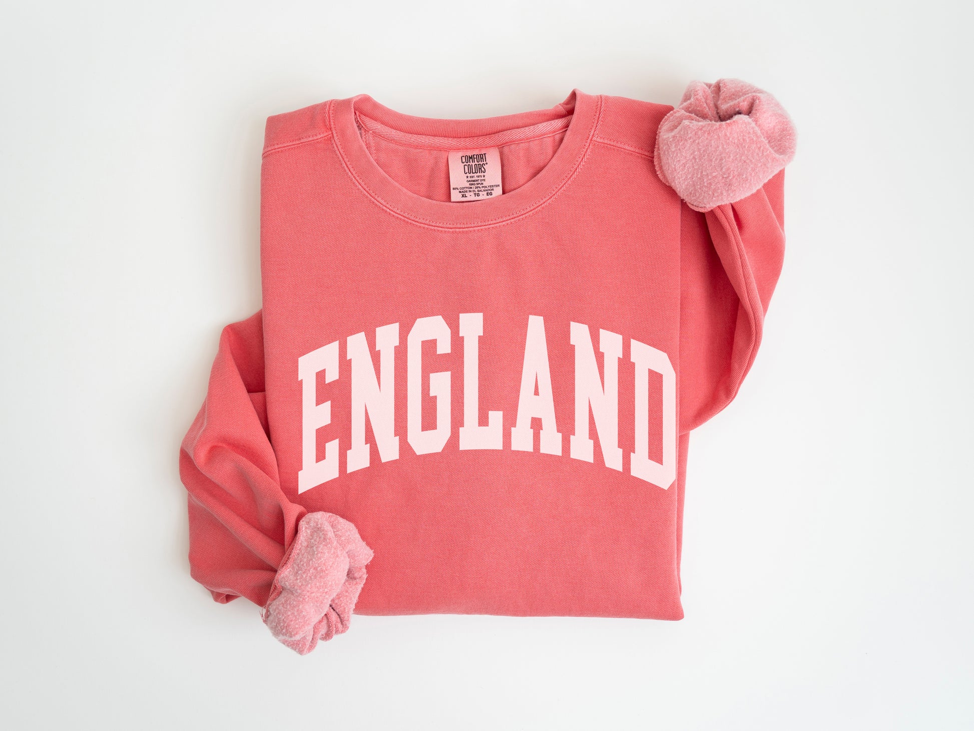 a red shirt with england on it and a pink bow