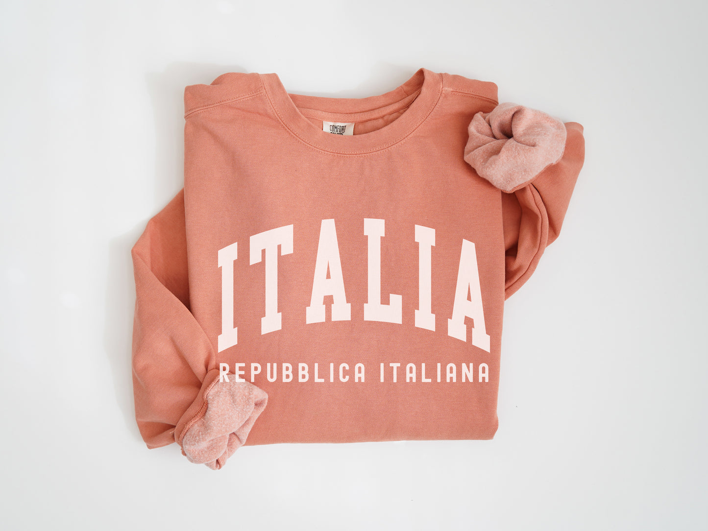 a pink sweatshirt with the word italia printed on it