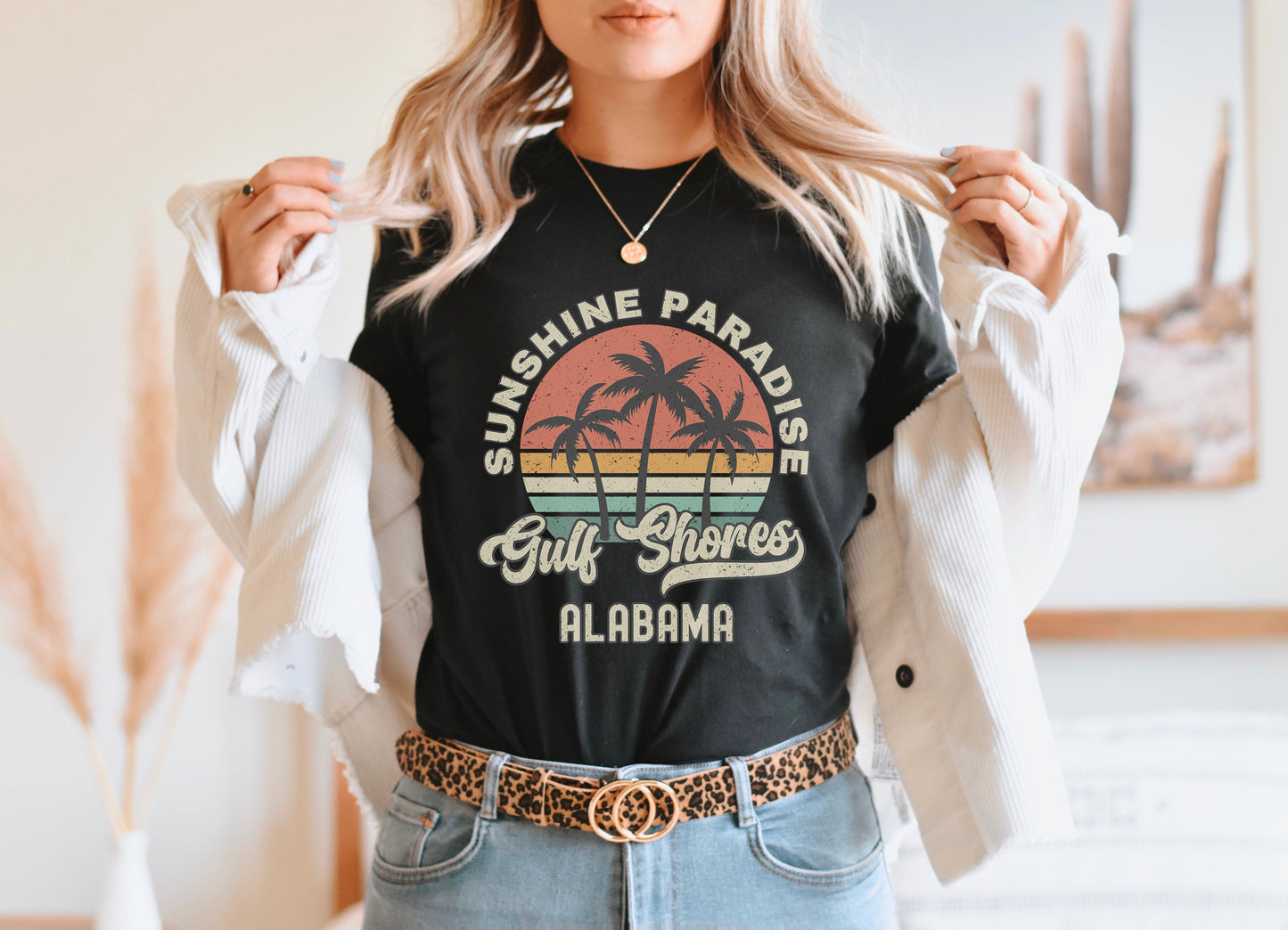 a woman wearing a black shirt with a palm tree on it