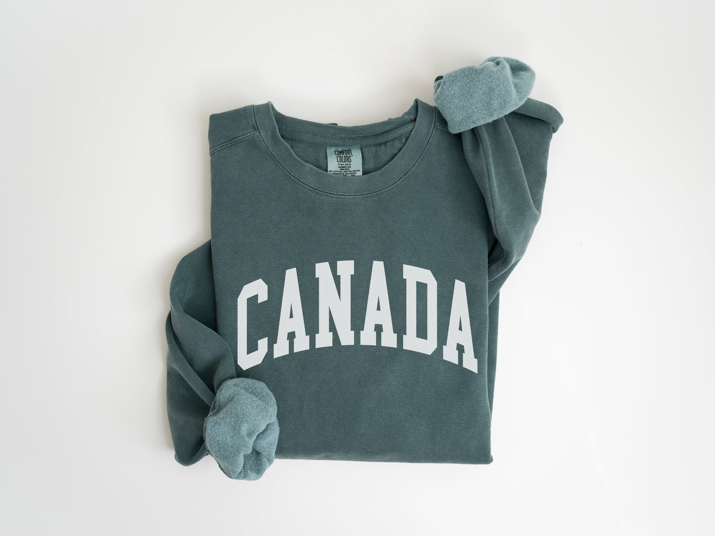 a green sweatshirt with the word canada on it