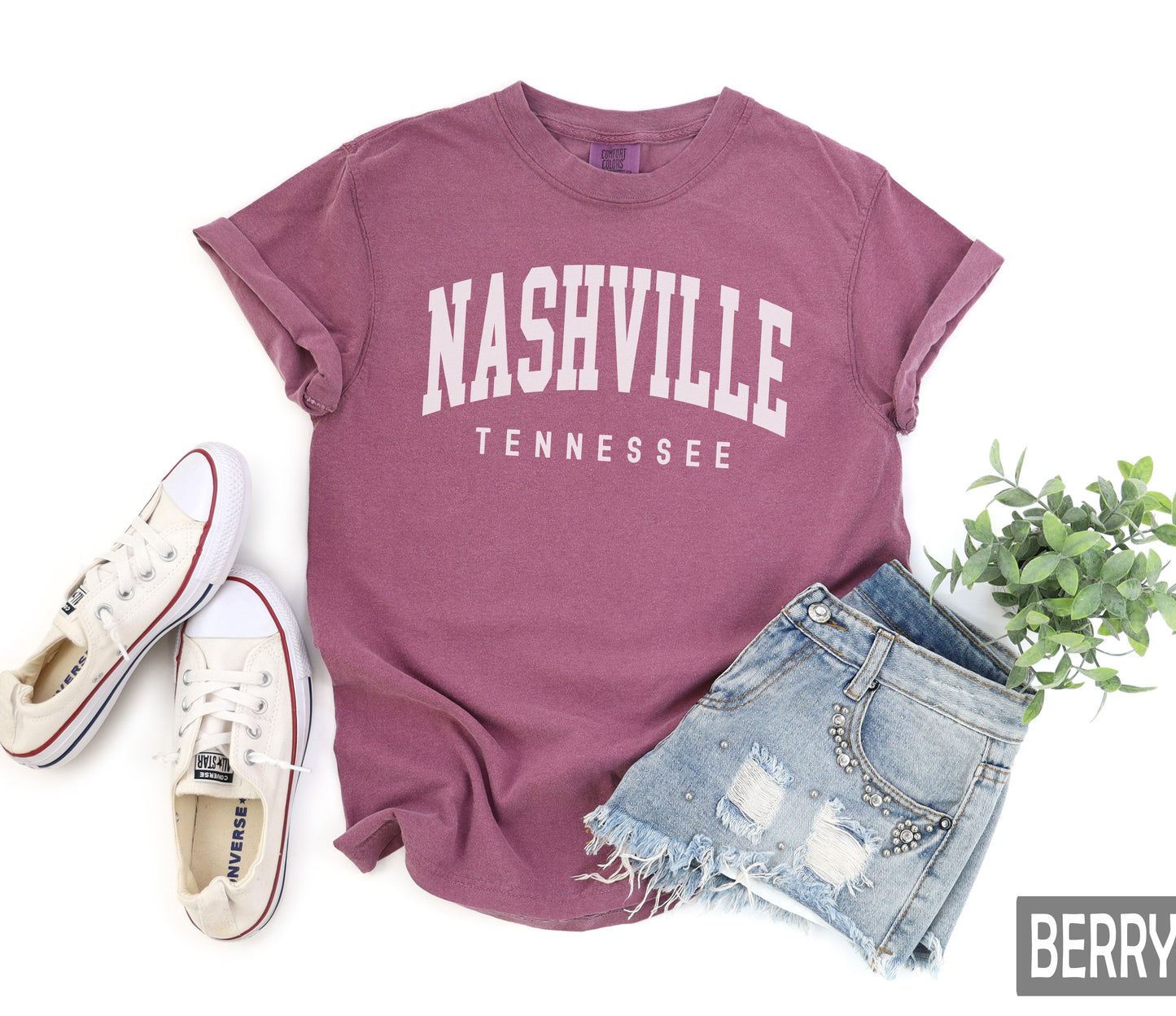 a t - shirt with the words nashville on it next to a pair of shorts