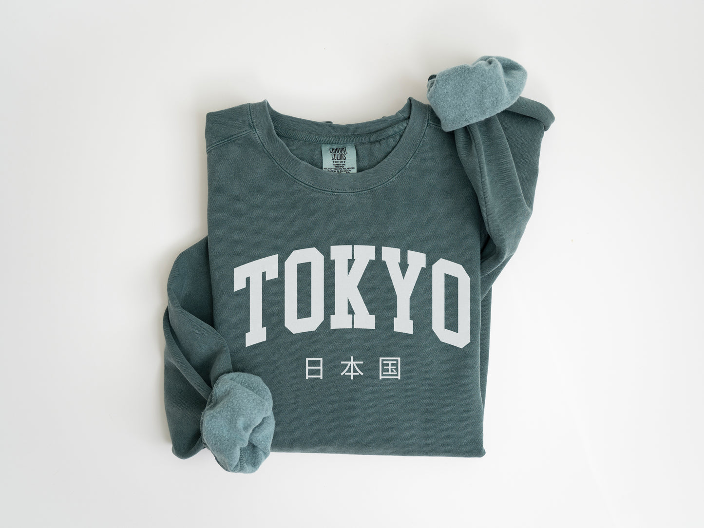 a green shirt with the word tokyo on it