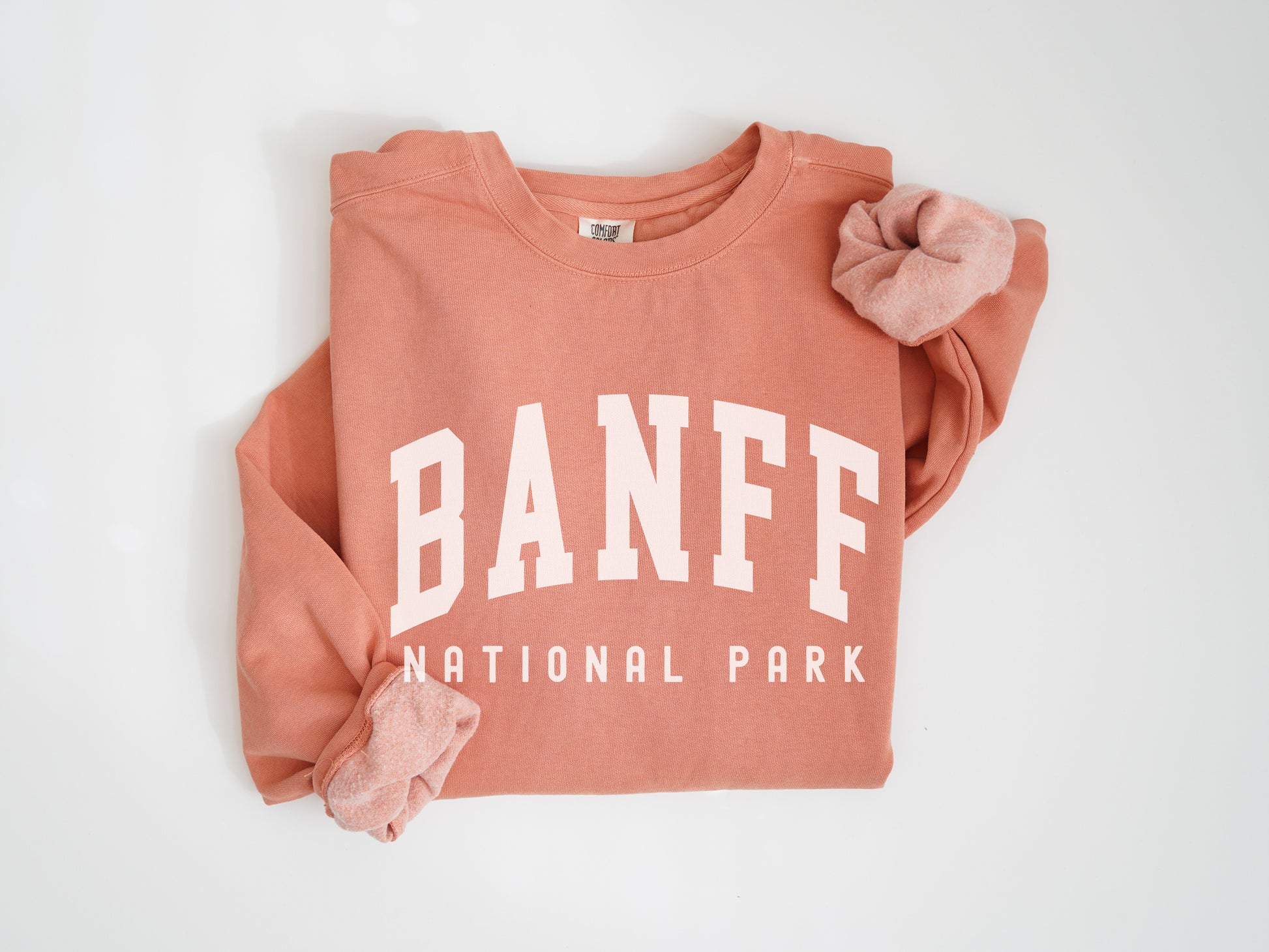 a pink sweatshirt with a pink bow on it