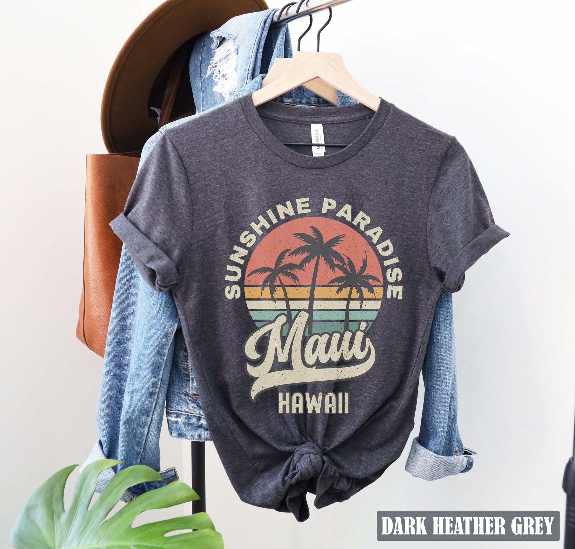 a t - shirt that says sunshine paradise hawaii hangs on a rack