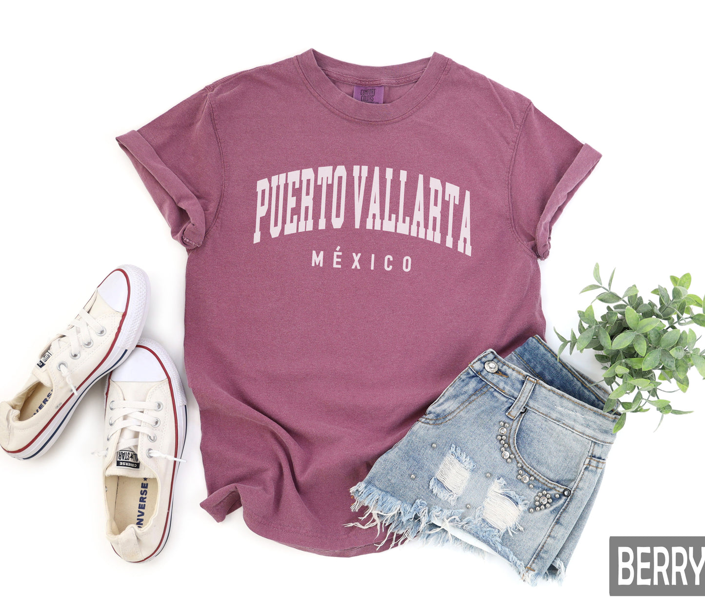 a t - shirt that says puerto vallata, next to a pair of