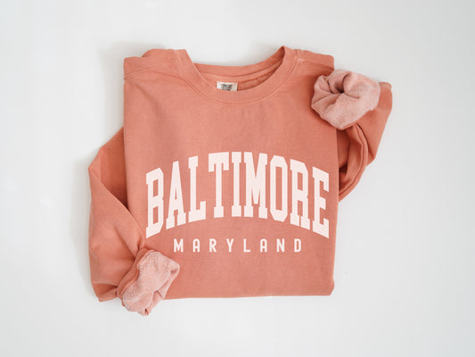 a pink sweatshirt with a bow on the front