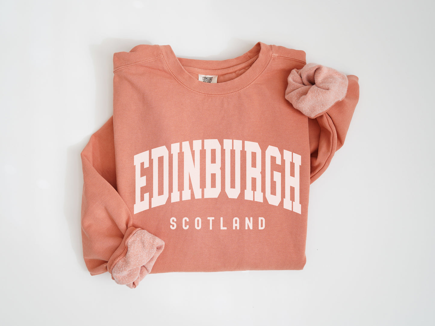 a pink sweatshirt with the word edinburgh printed on it