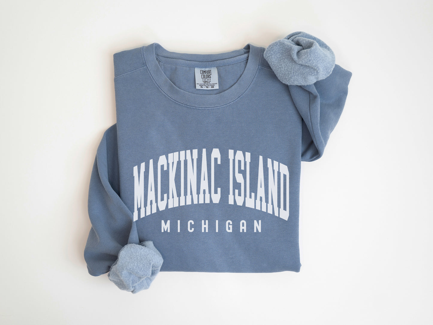 a blue shirt with the words mackin island on it