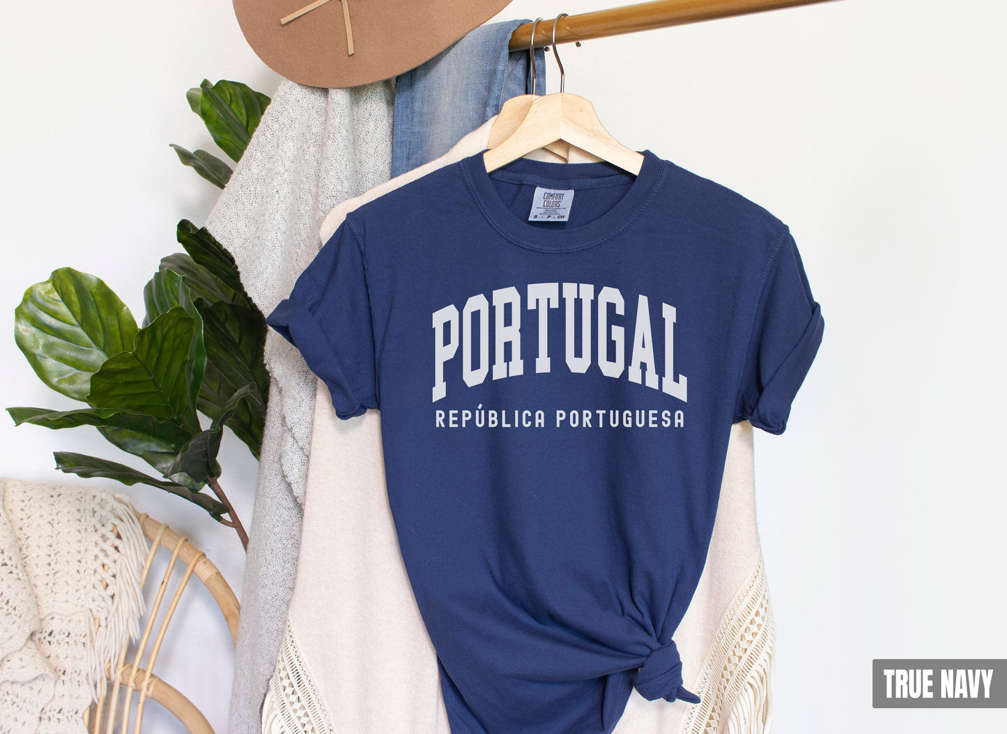 a t - shirt that says portugal hanging on a rack