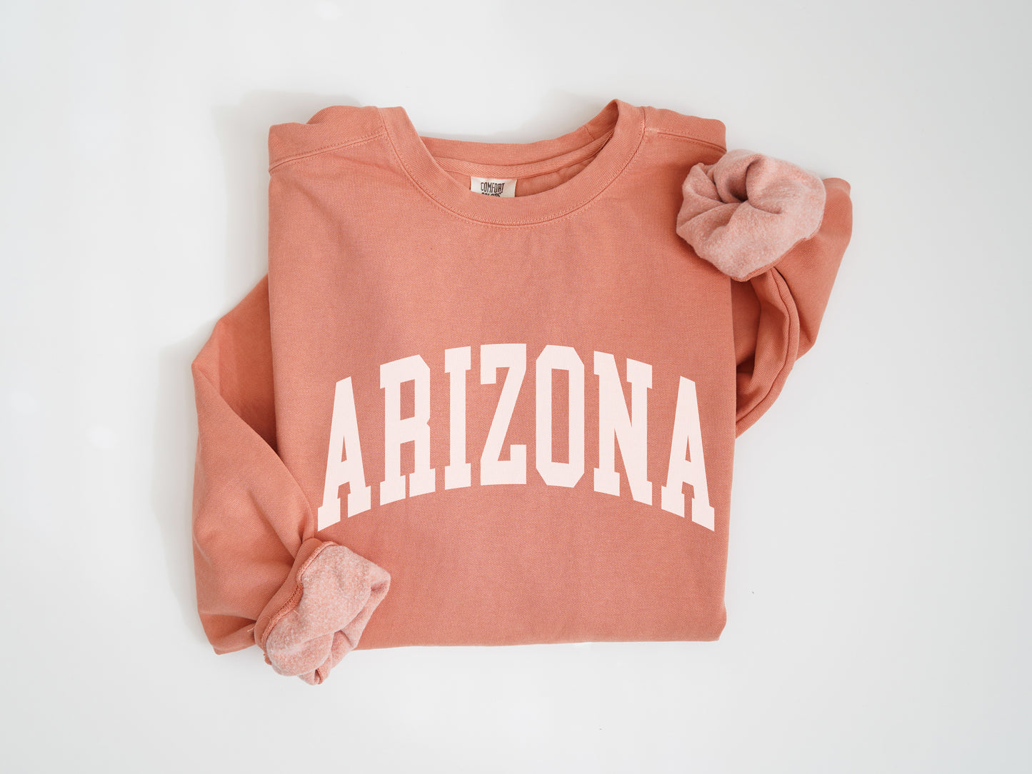 a pink sweatshirt with the word arizona printed on it