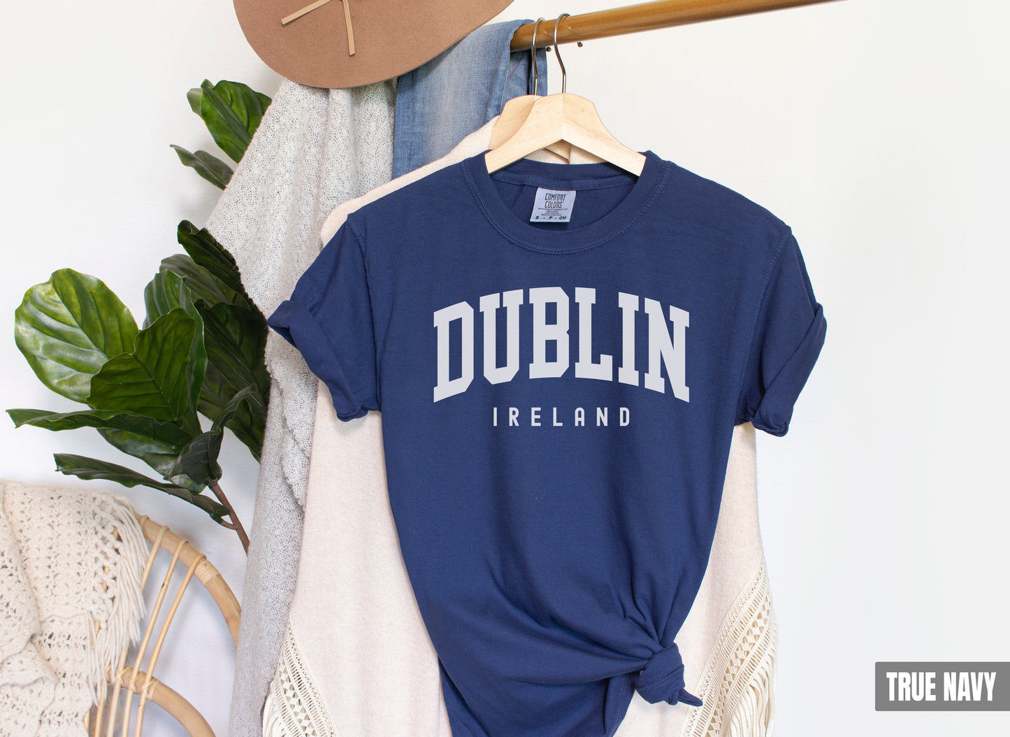 a blue dublin t - shirt hanging on a clothes rack