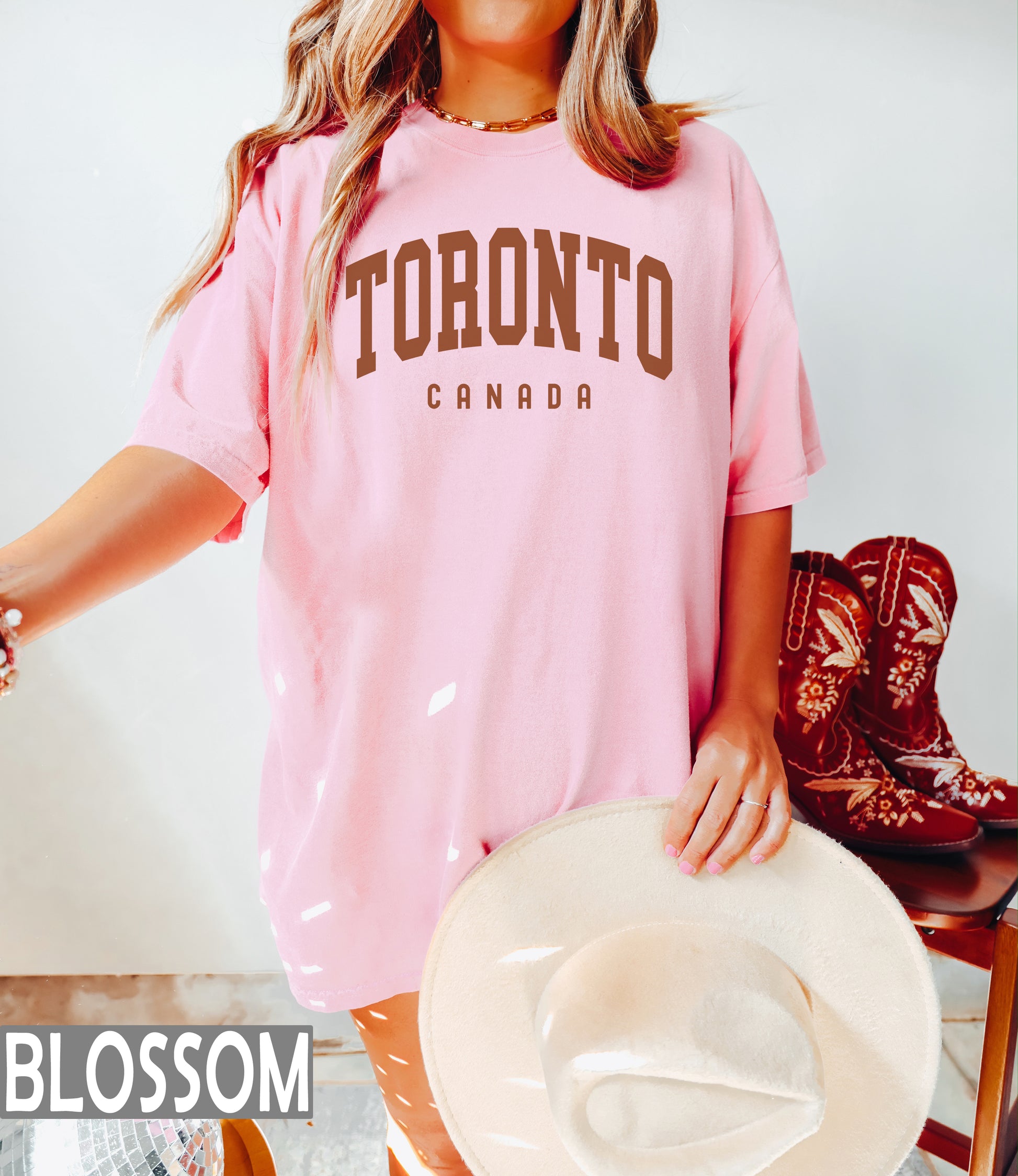 a woman in a pink shirt and cowboy boots