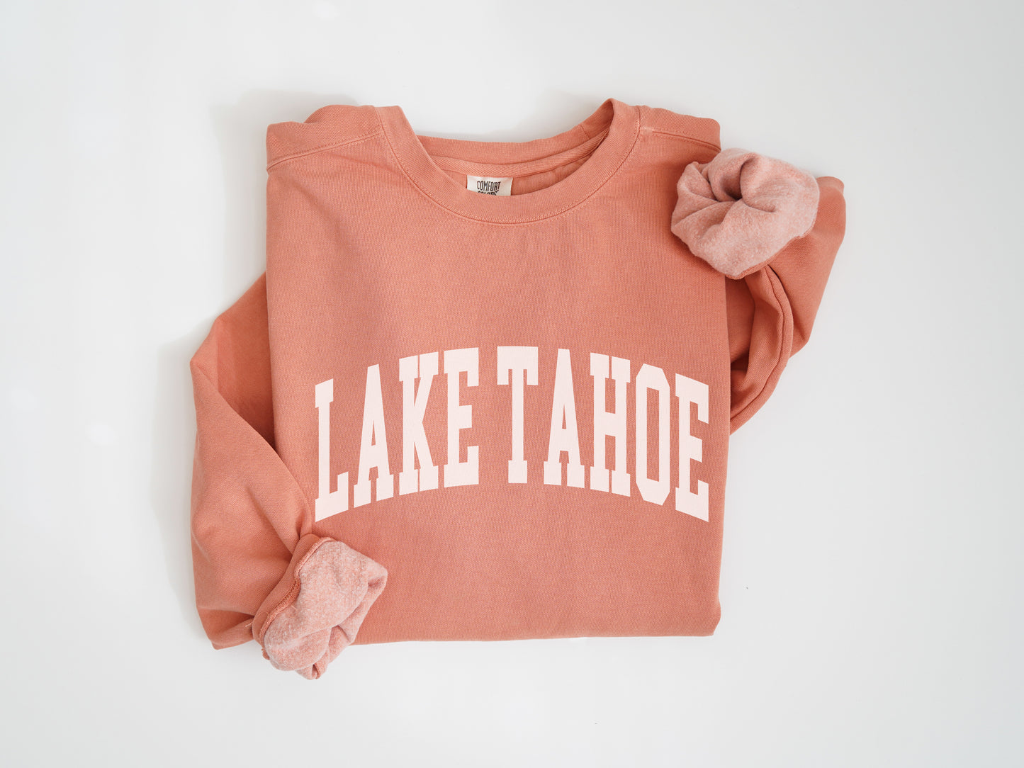 a pink sweatshirt with the word lake tahoe printed on it