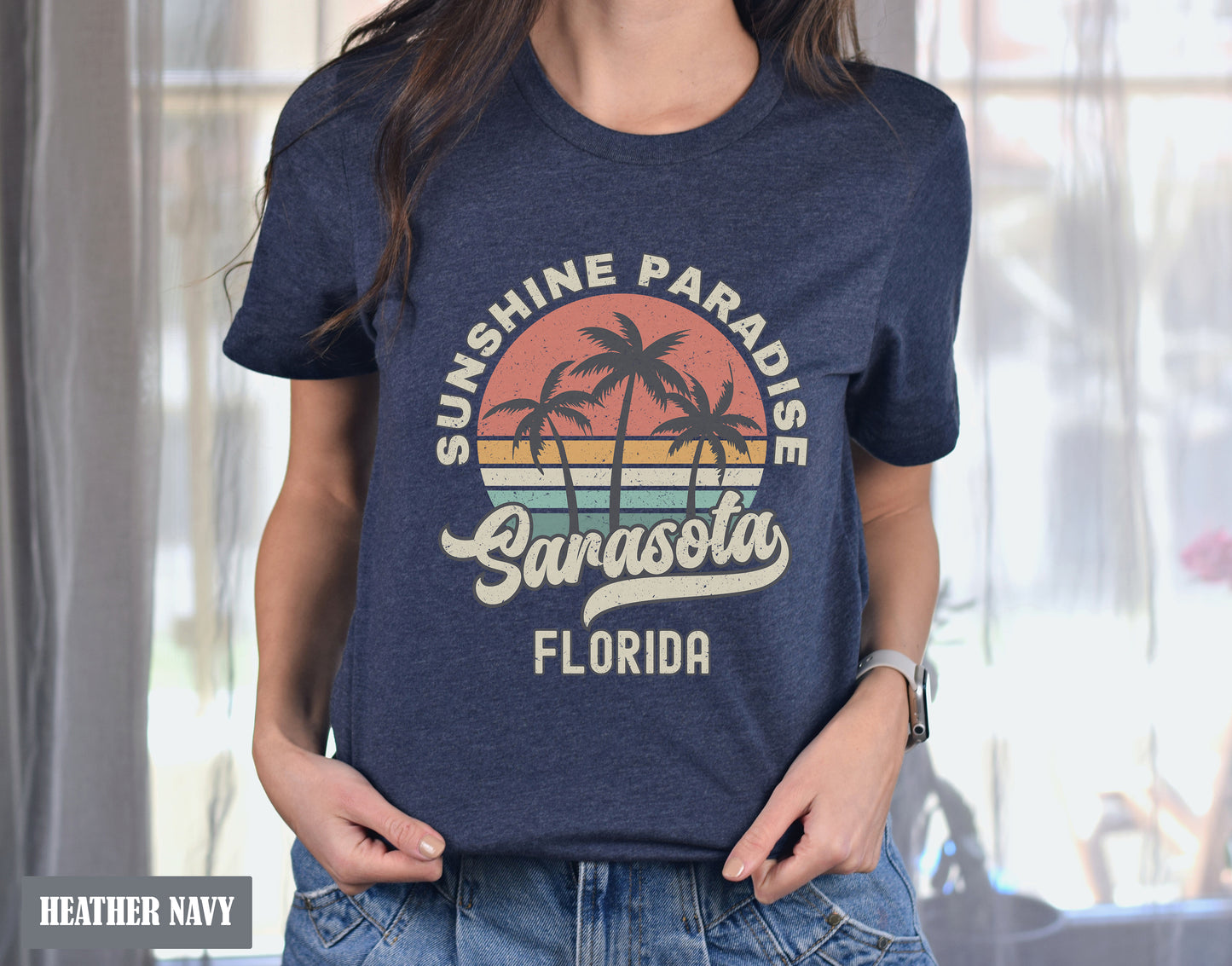 a woman wearing a blue shirt that says sunshine paradise in front of a window