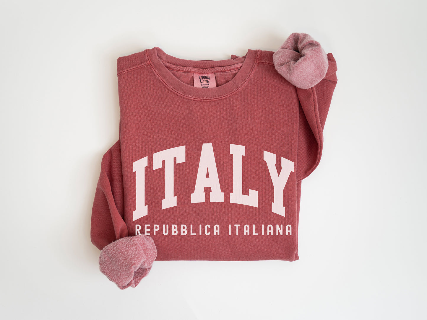 a red t - shirt with the word italy printed on it