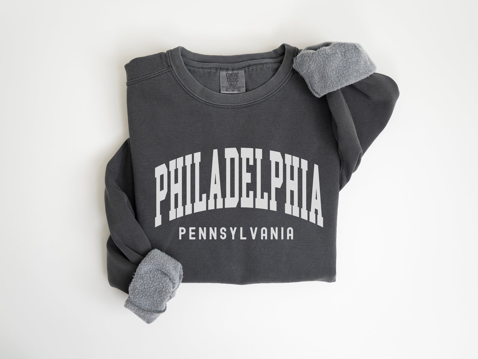 a black sweatshirt with white philadelphia on it