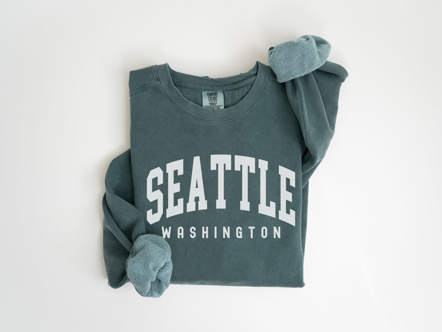 a green sweatshirt with the word seattle on it