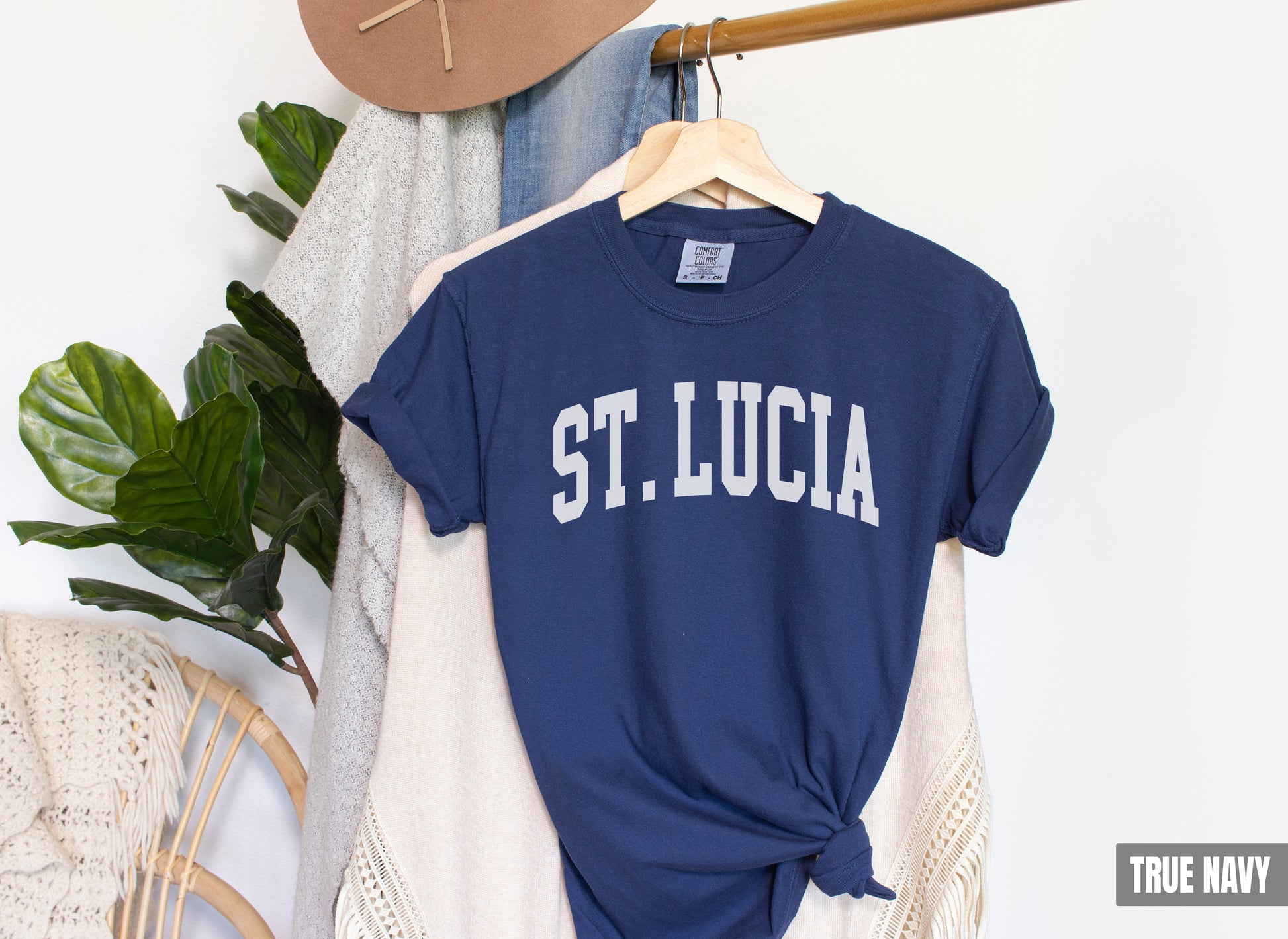 a t - shirt that says st lucia is hanging on a rack