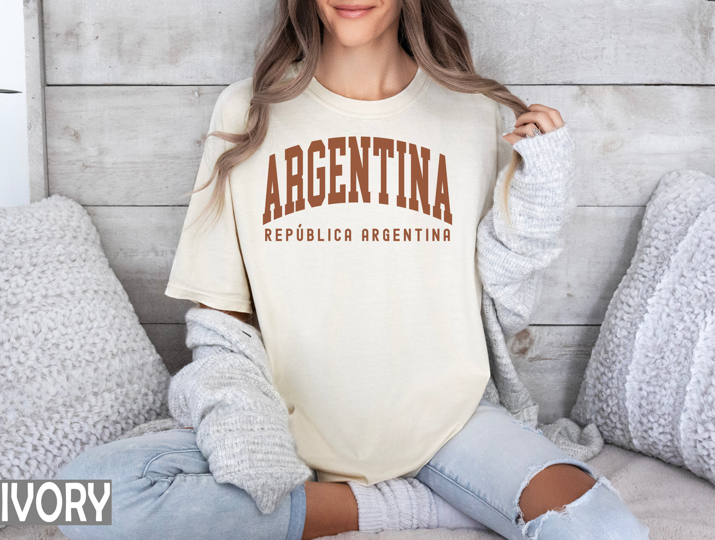 a woman sitting on a bed wearing a shirt that says argentina