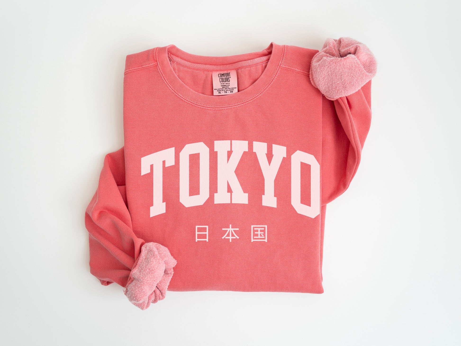 a red shirt with a white tokyo print on it