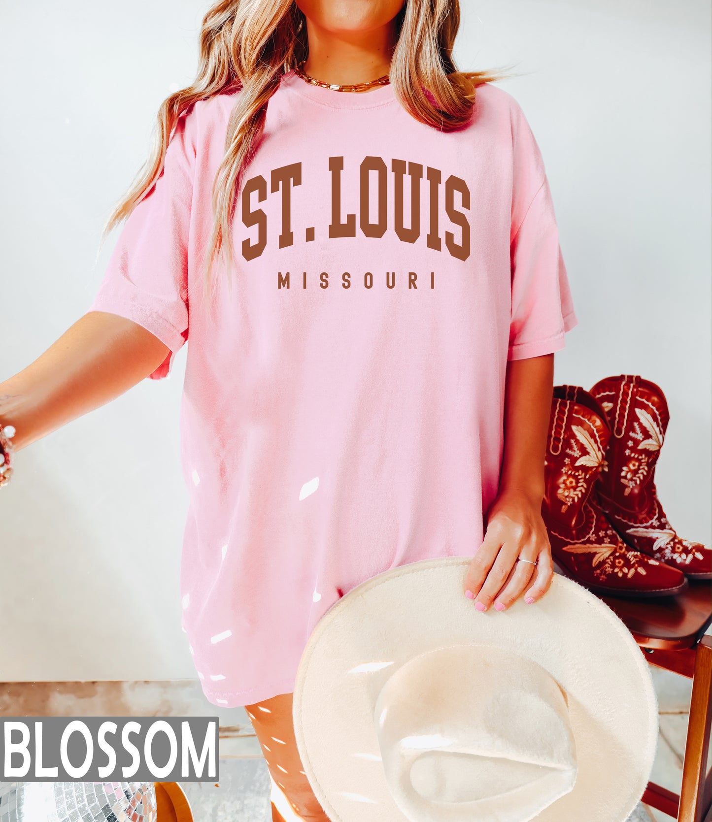 a woman in a pink shirt and cowboy boots