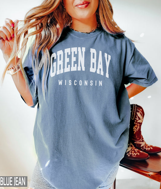 a woman wearing a green bay wisconsin t - shirt