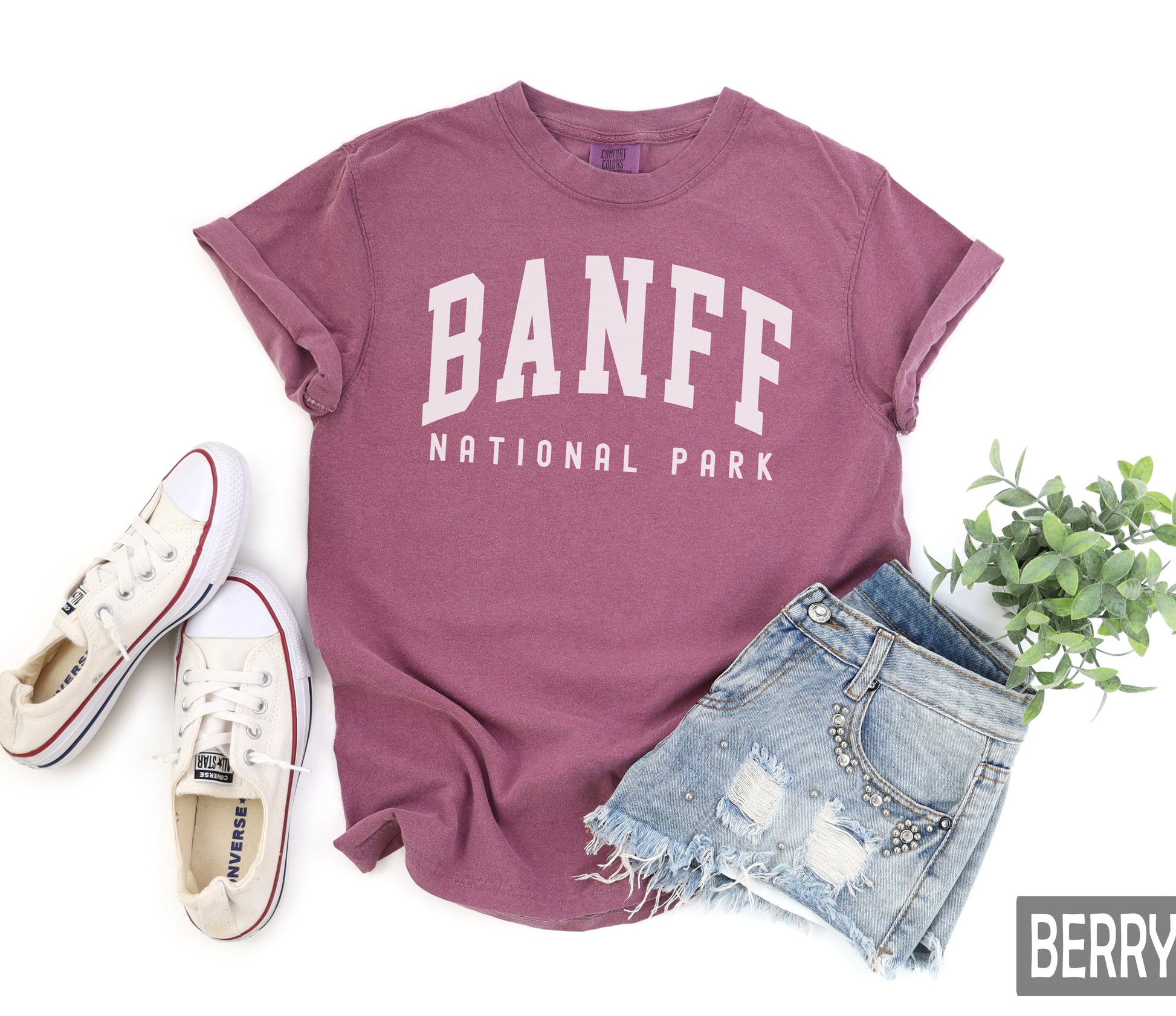 a t - shirt that says banff national park next to a pair of shorts